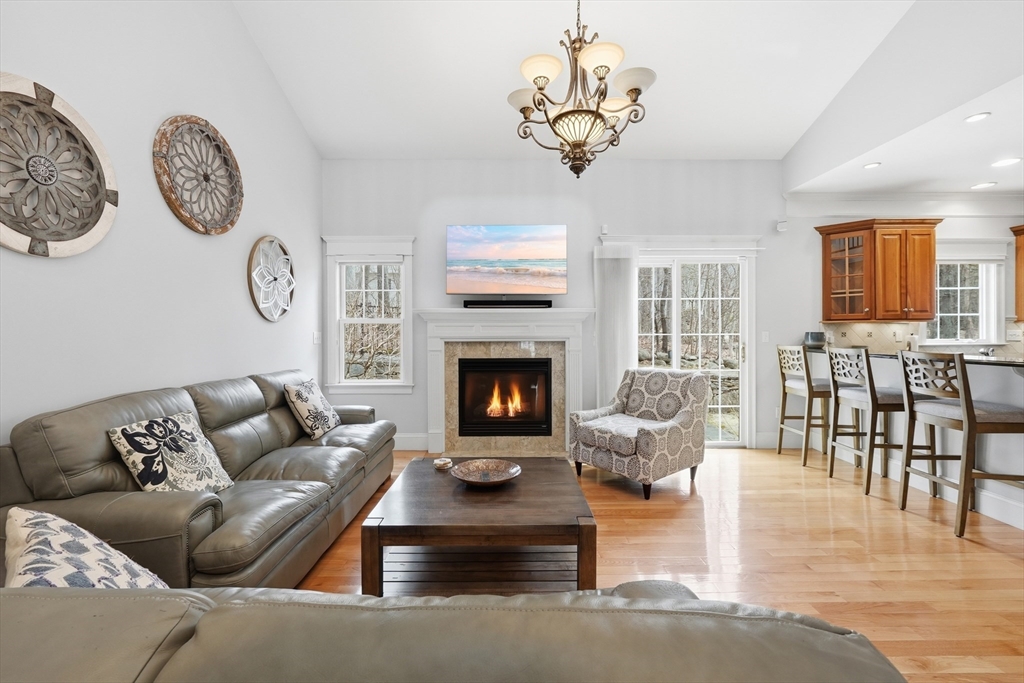 22 McNeil Circle, Unit 22 Hopkinton, MA 01748 - Photo 16 of 42 a living room with furniture a fireplace and wooden floor