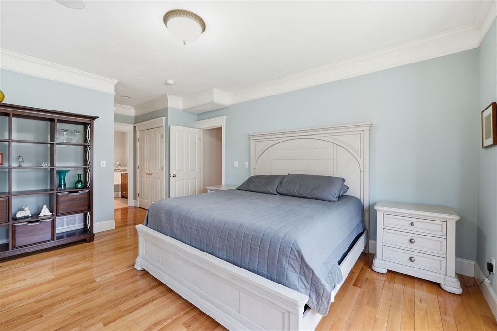 22 McNeil Circle, Unit 22 Hopkinton, MA 01748 - Photo 18 of 42 a bedroom with a bed and a dresser