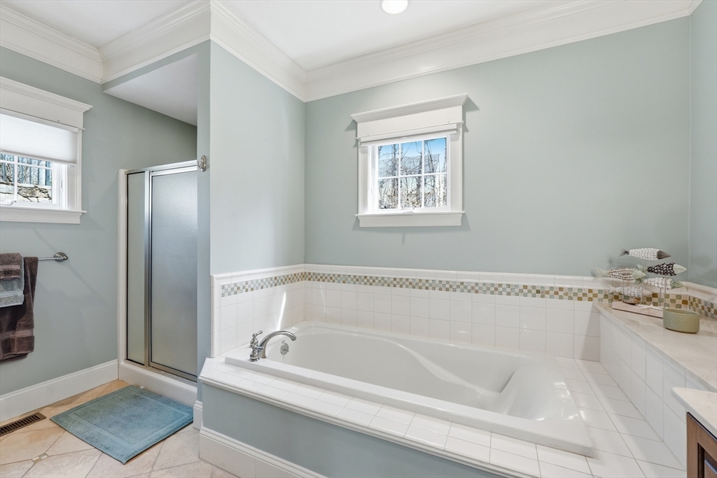 22 McNeil Circle, Unit 22 Hopkinton, MA 01748 - Photo 23 of 42 a white bath tub sitting next to a white sink