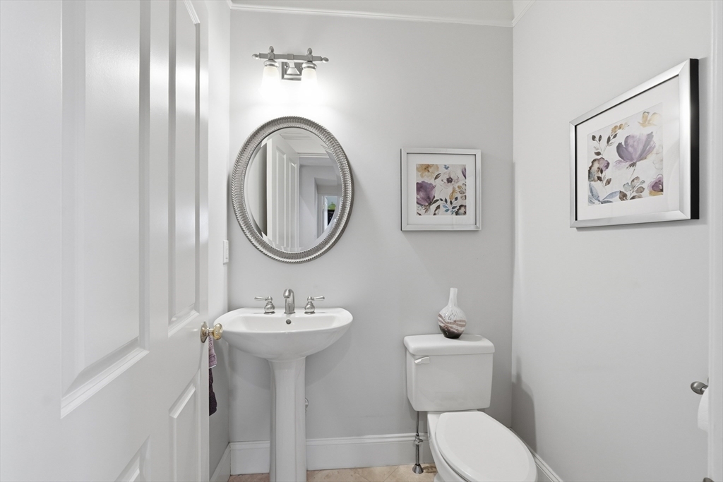 22 McNeil Circle, Unit 22 Hopkinton, MA 01748 - Photo 24 of 42 a bathroom with a toilet a sink and a mirror