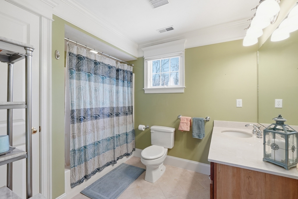 22 McNeil Circle, Unit 22 Hopkinton, MA 01748 - Photo 30 of 42 a bathroom with a granite countertop sink toilet a mirror and shower
