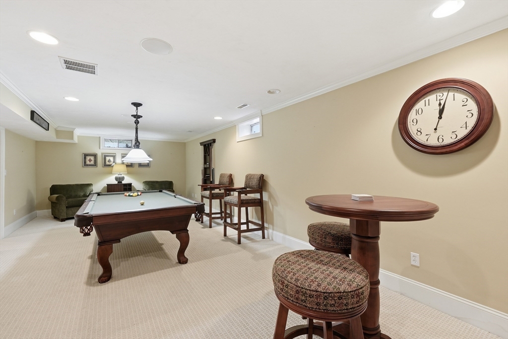 22 McNeil Circle, Unit 22 Hopkinton, MA 01748 - Photo 34 of 42 a room with furniture and a chandelier