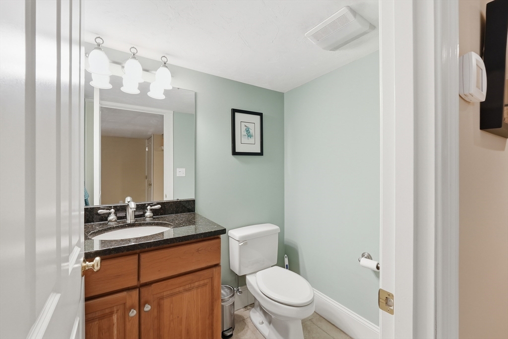 22 McNeil Circle, Unit 22 Hopkinton, MA 01748 - Photo 38 of 42 a bathroom with a sink a toilet and a mirror