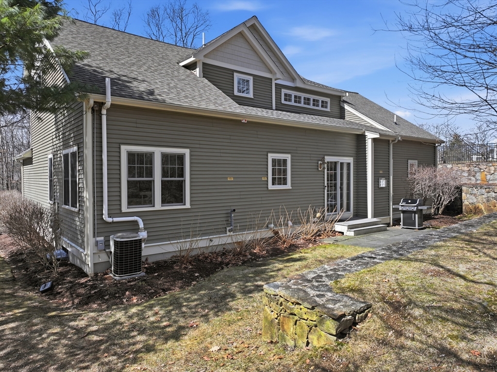 22 McNeil Circle, Unit 22 Hopkinton, MA 01748 - Photo 40 of 42 a front view of a house with garden