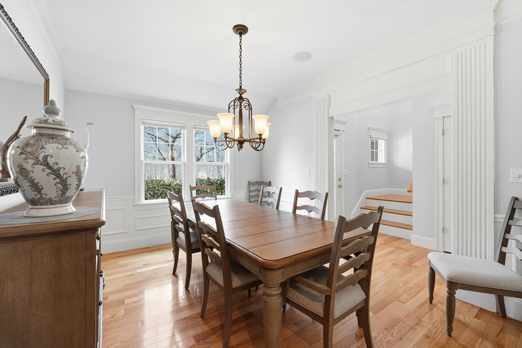 22 McNeil Circle, Unit 22 Hopkinton, MA 01748 - Photo 6 of 42 a view of a dining room and livingroom with furniture wooden floor a chandelier