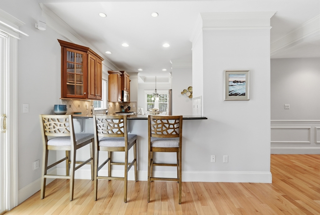 22 McNeil Circle, Unit 22 Hopkinton, MA 01748 - Photo 7 of 42 a view of a dining room with furniture and wooden floor