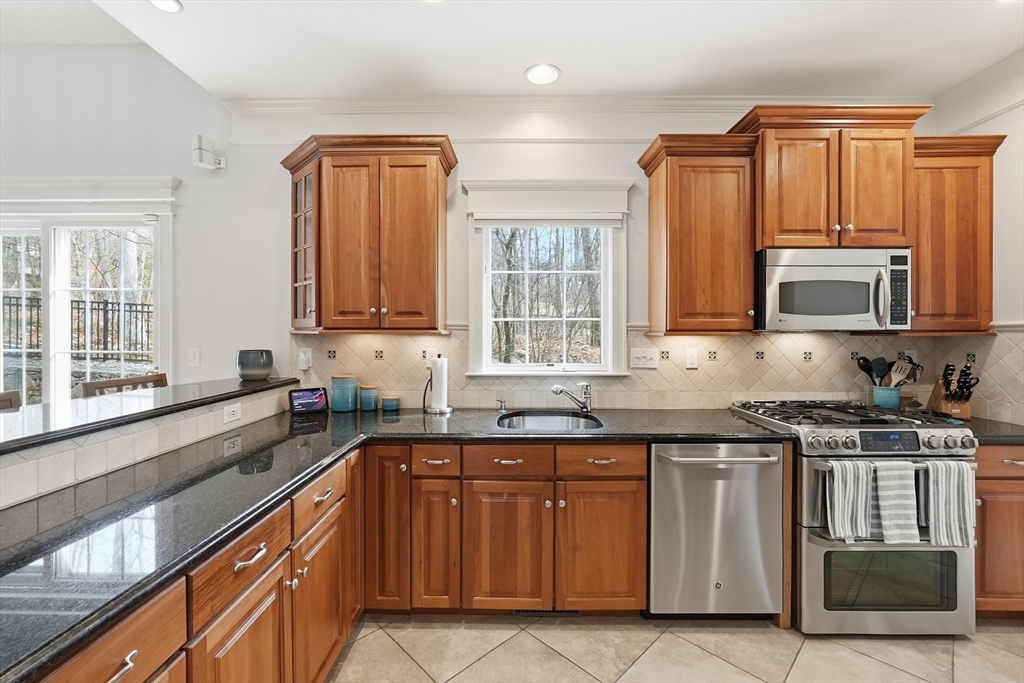 22 McNeil Circle, Unit 22 Hopkinton, MA 01748 - Photo 8 of 42 a kitchen with stainless steel appliances granite countertop a sink stove and microwave