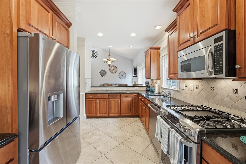 22 McNeil Circle, Unit 22 Hopkinton, MA 01748 - Photo 10 of 42 a kitchen with stainless steel appliances granite countertop a stove top oven a sink dishwasher a refrigerator and a microwave