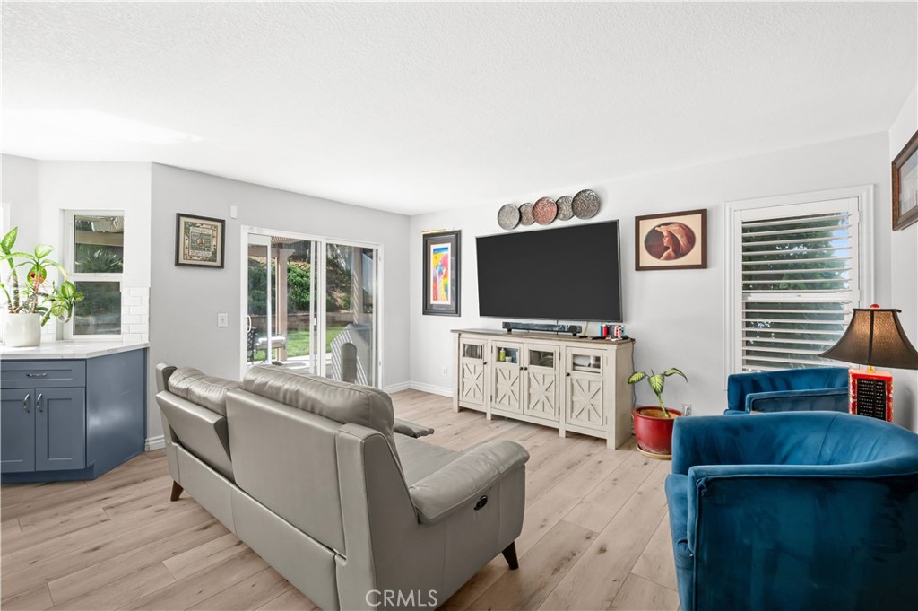 19465 Kinnow Lane Riverside, CA 92508 - Photo 18 of 61 a living room with furniture and a flat screen tv