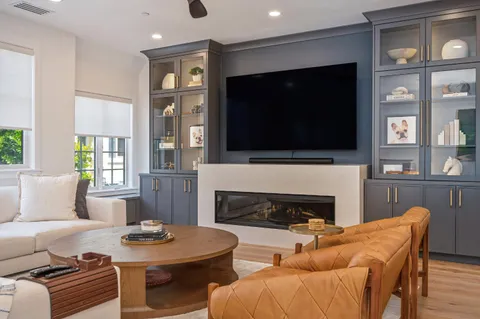 a living room with fireplace furniture and a flat screen tv