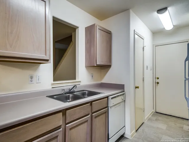 a kitchen with a sink and cabinets