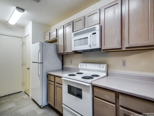 a kitchen with stainless steel appliances granite countertop a refrigerator sink and cabinets