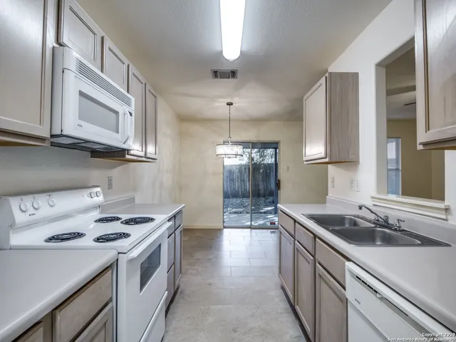 a kitchen that has a sink and a stove