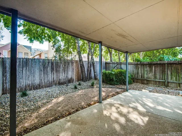 a backyard of a house with a lots of trees and plants