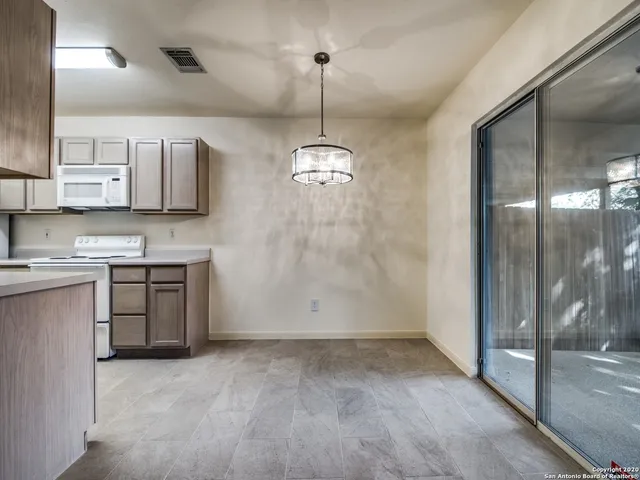 a kitchen with kitchen island granite countertop a stove a sink and a refrigerator