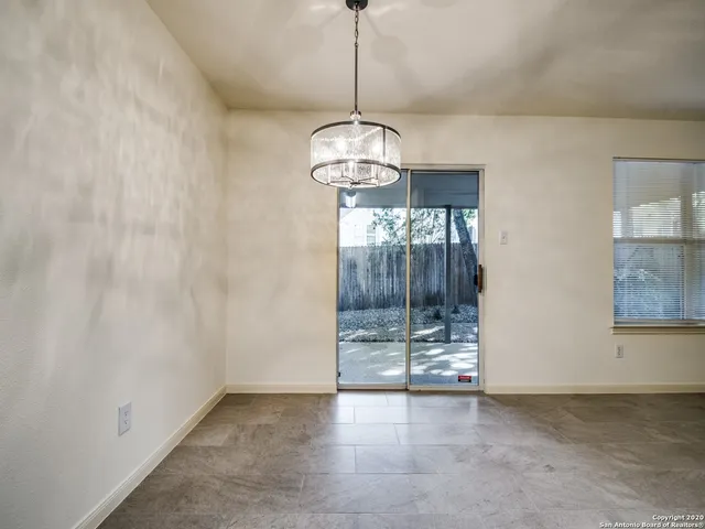 a view of a room with wooden floor and windows