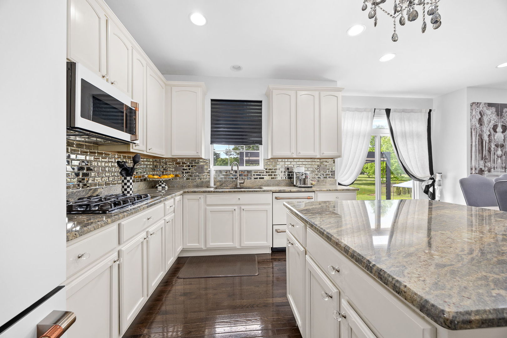 2297 Deerpath Road Bolingbrook, IL 60490 - Photo 14 of 46 a kitchen with kitchen island granite countertop a sink window and cabinets