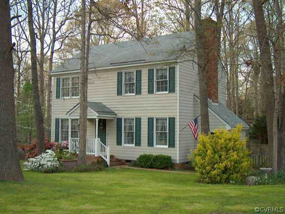 a front view of a house with a garden and plants