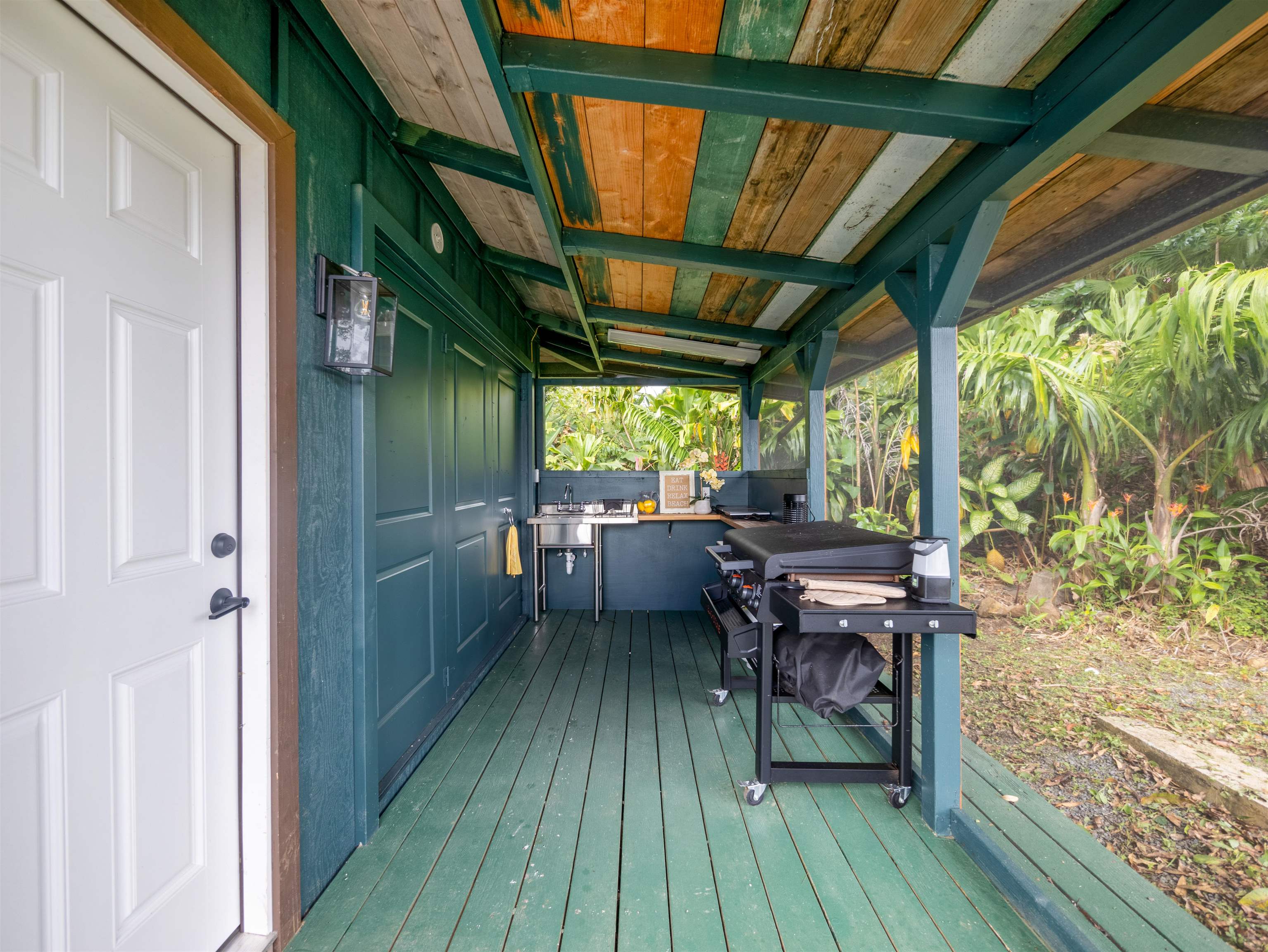 44 Hanauana Road Haiku, HI 96708 - Photo 14 of 45 a view of a chairs and table in deck with wooden floor