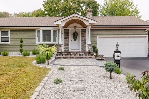 a front view of a house with garden