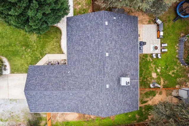 a front view of a house with a yard and trees
