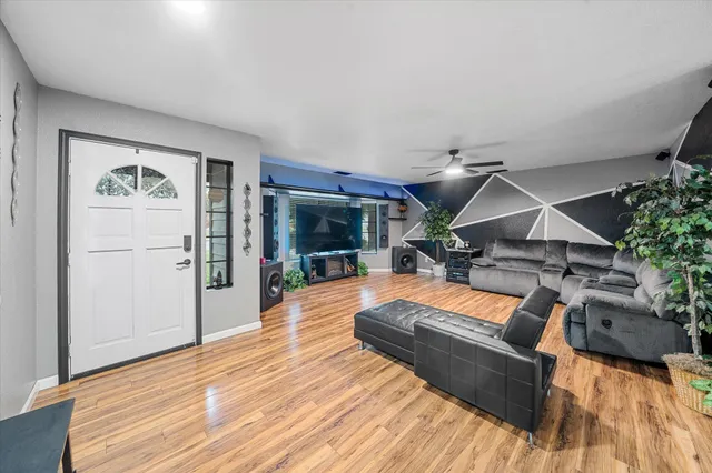 a view of a dining room with furniture a chandelier and window