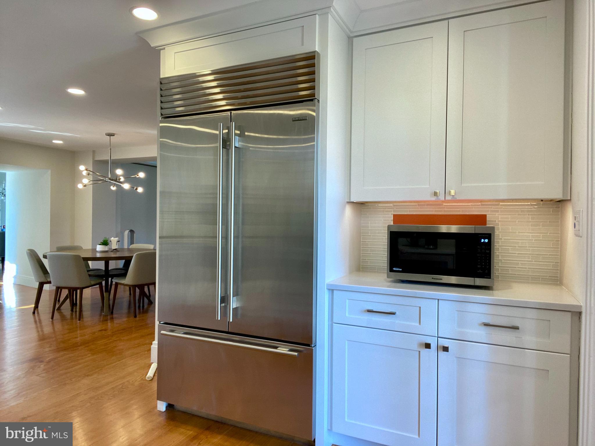 121 Upnor Road Baltimore, MD 21212 - Photo 32 of 79 a kitchen with granite countertop a refrigerator and a stove top oven