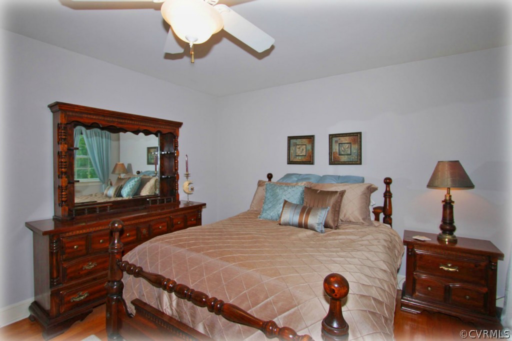 13321 Kingsmill Road Midlothian, VA 23113 - Photo 6 of 14 a bedroom with a bed and a flat tv screen on dresser