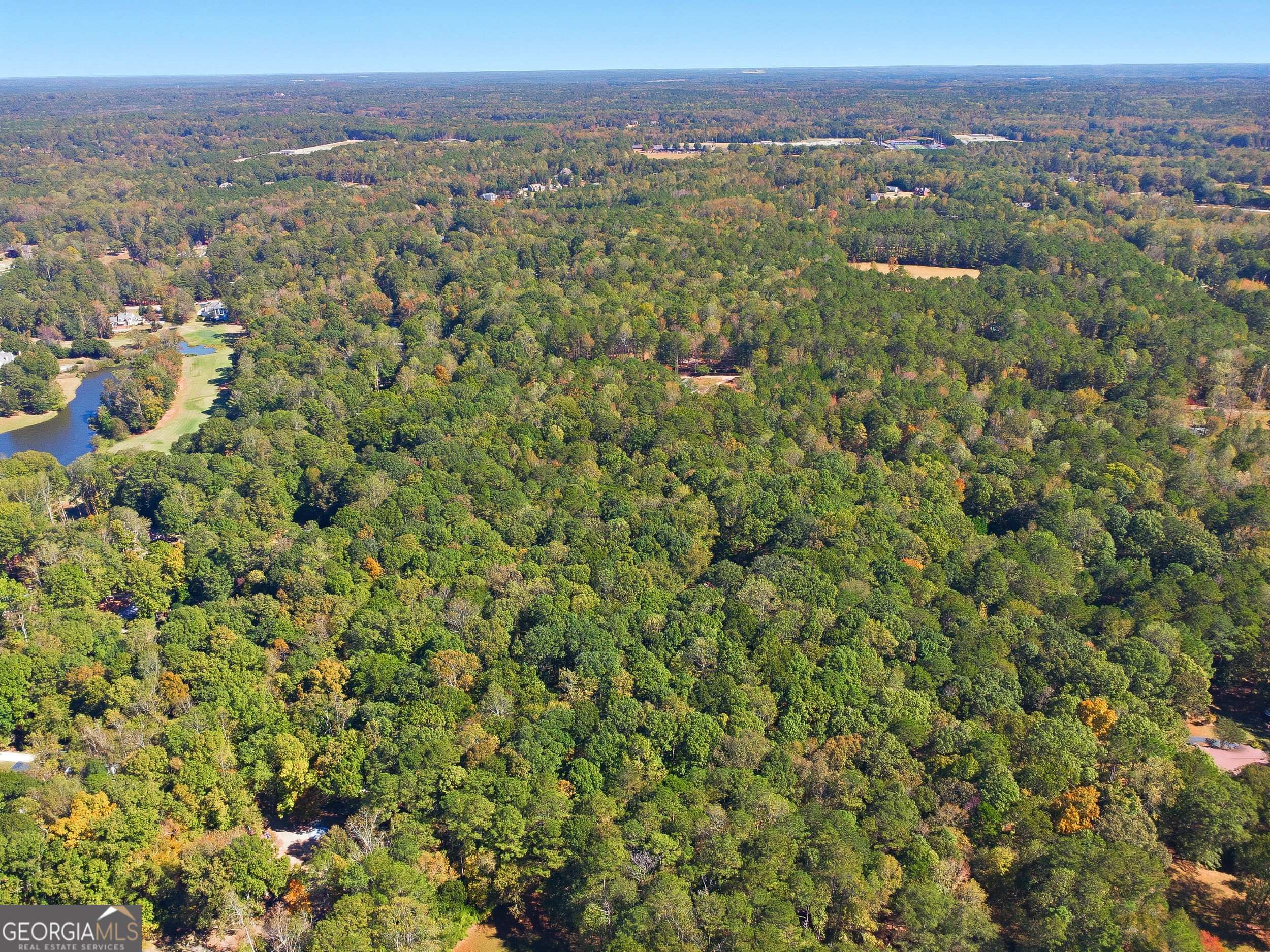 0 Busbin Road Fayetteville, GA 30215 - Photo 2 of 8 an aerial view of a houses with a lush green hillside