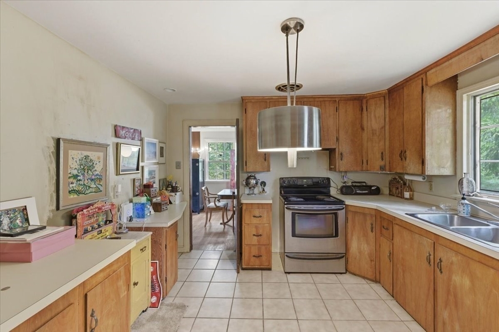 99 Brook Road Sharon, MA 02067 - Photo 12 of 37 a kitchen with a sink stove and cabinets