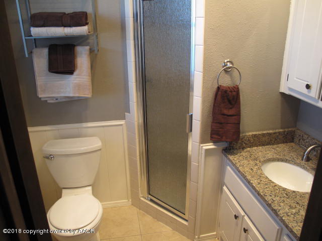8108 Goodnight Trail Amarillo, TX 79110 - Photo 13 of 17 a bathroom with a granite countertop toilet and a sink