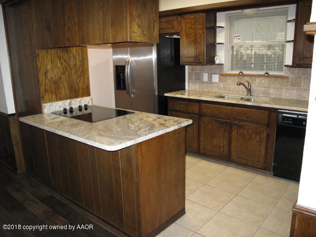 8108 Goodnight Trail Amarillo, TX 79110 - Photo 16 of 17 a kitchen with stainless steel appliances a sink stove and refrigerator