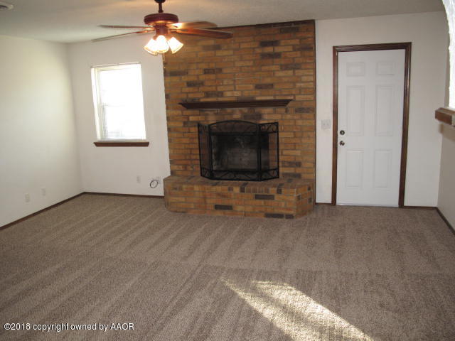 8108 Goodnight Trail Amarillo, TX 79110 - Photo 4 of 17 a view of a livingroom with an empty space and a fireplace