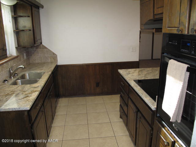 8108 Goodnight Trail Amarillo, TX 79110 - Photo 6 of 17 a kitchen with a sink a stove and cabinets