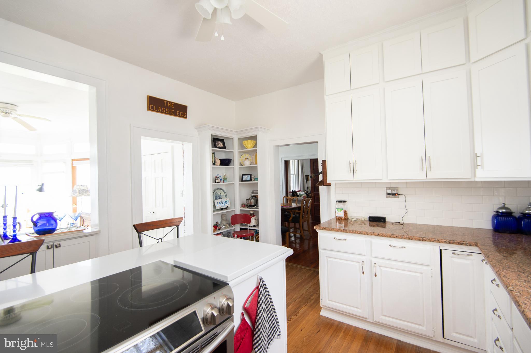 1 West End Avenue Cambridge, MD 21613 - Photo 11 of 33 a open kitchen with stainless steel appliances granite countertop a sink dishwasher and cabinets with wooden floor