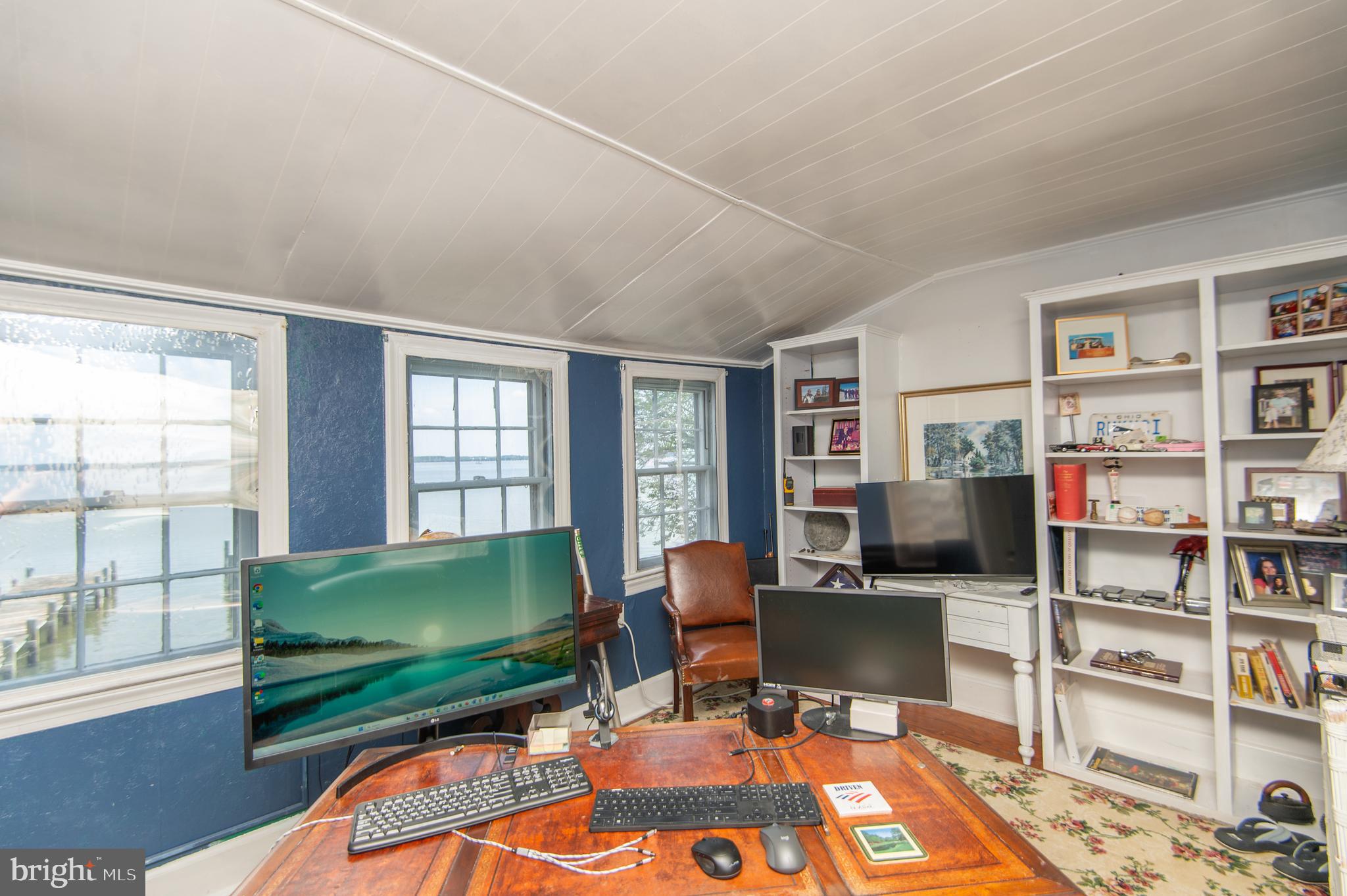 1 West End Avenue Cambridge, MD 21613 - Photo 22 of 33 a living room with furniture a bookshelf and a window