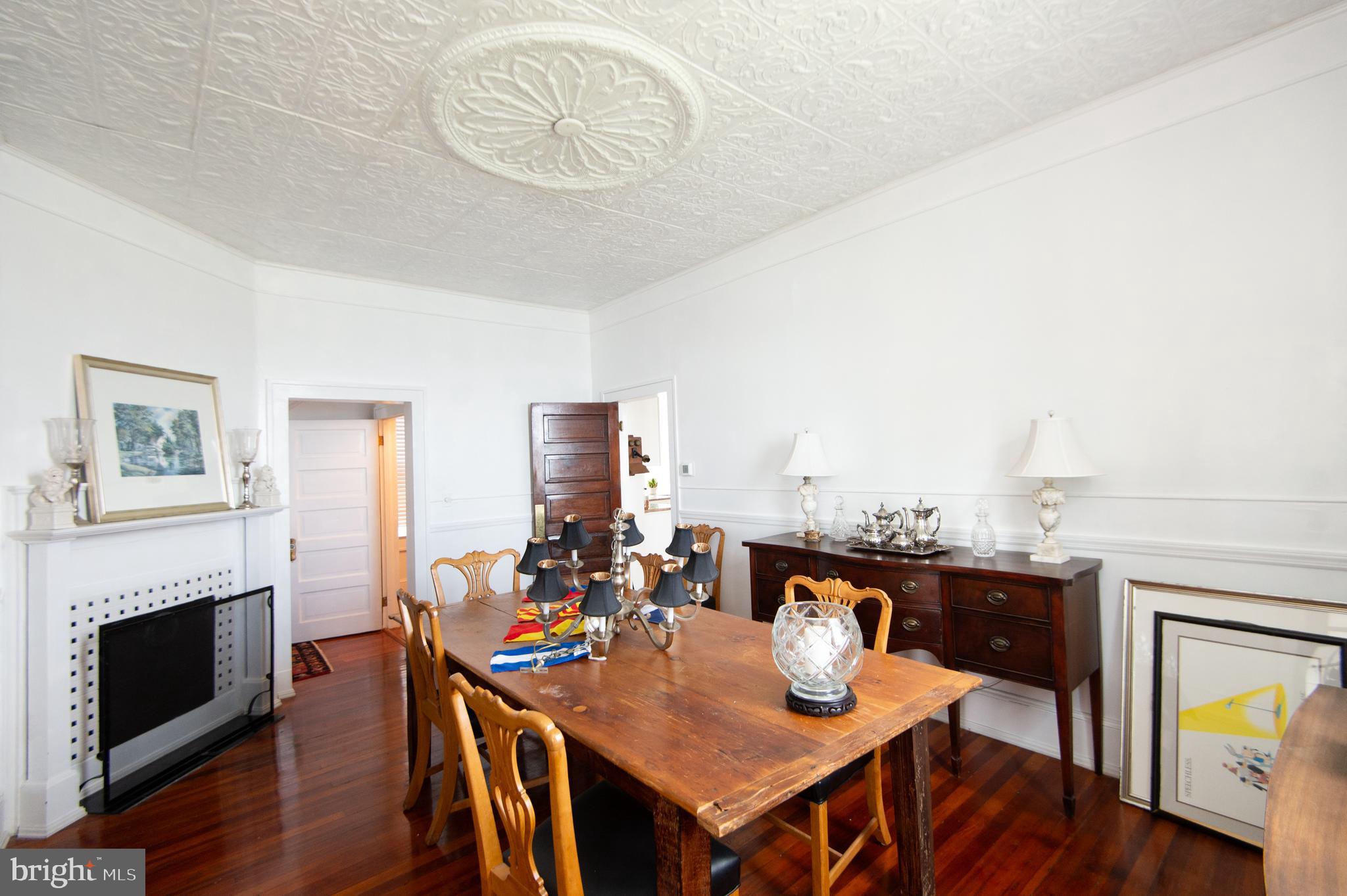 1 West End Avenue Cambridge, MD 21613 - Photo 7 of 33 a view of a dining room with furniture a chandelier and wooden floor