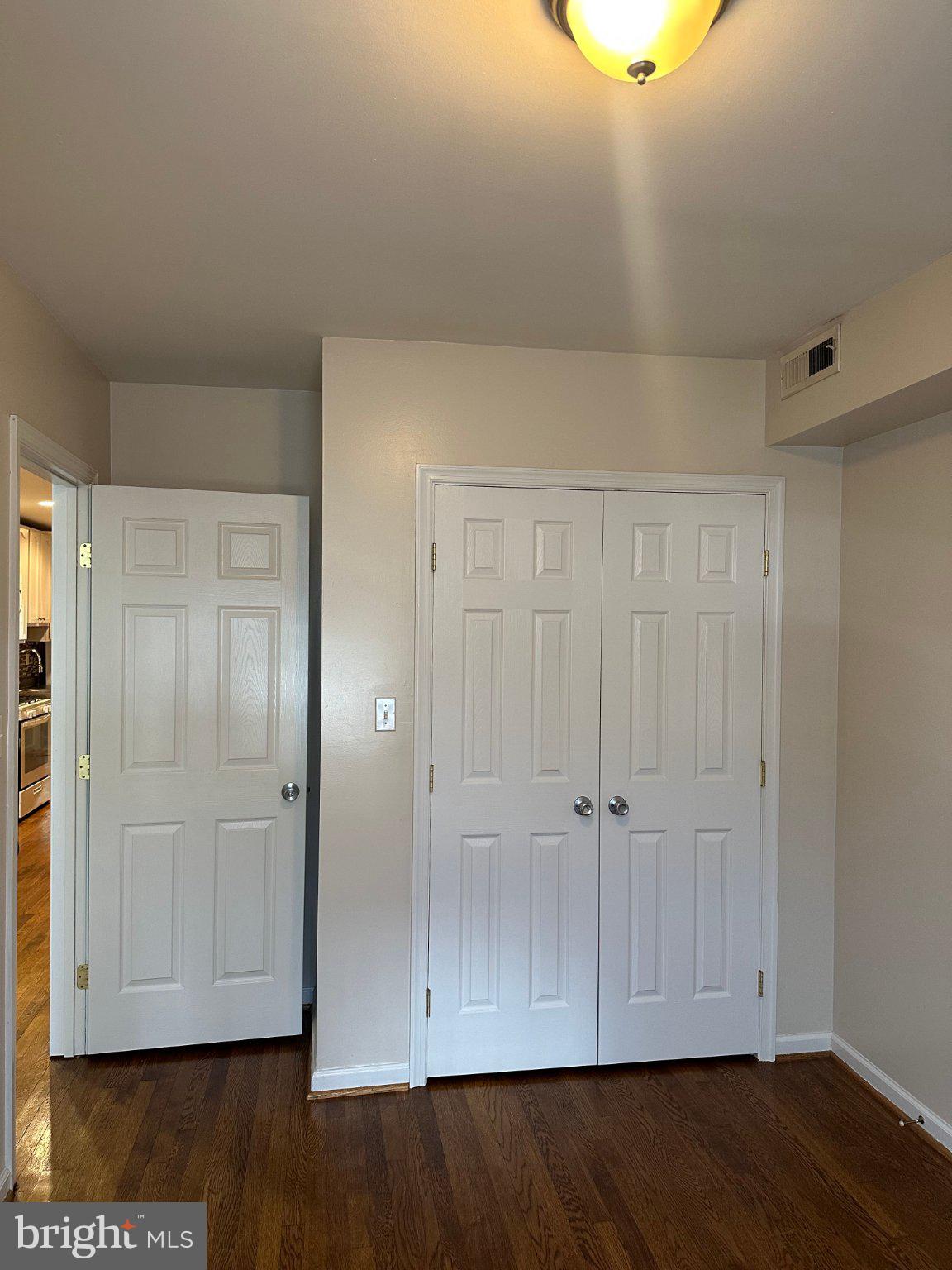 1913 Rosedale Street Northeast, Unit 1 Washington, DC 20002 - Photo 11 of 12 an empty room with wooden floor