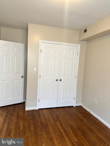 1913 Rosedale Street Northeast, Unit 1 Washington, DC 20002 - Photo 4 of 12 an empty room with wooden floor