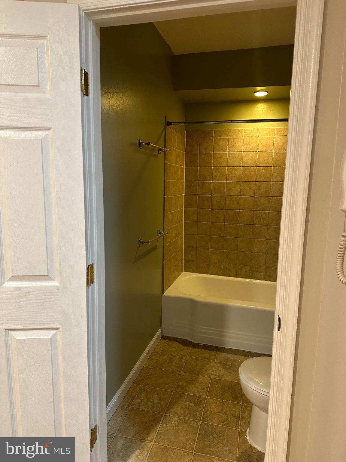 1913 Rosedale Street Northeast, Unit 1 Washington, DC 20002 - Photo 7 of 12 a bathroom with a bathtub and a shower
