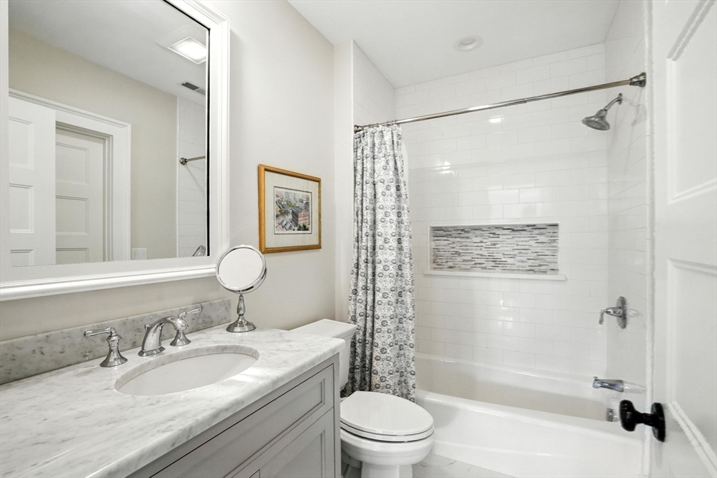 15 Winthrop Road Lexington, MA 02421 - Photo 28 of 39 a bathroom with a granite countertop sink toilet mirror and shower