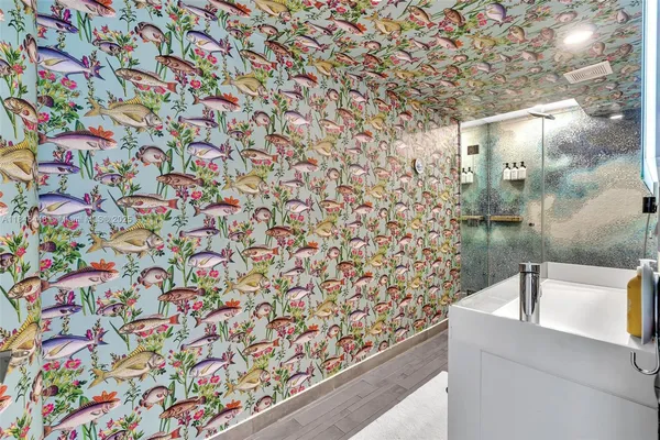 a bathroom with a sink toilet and shower