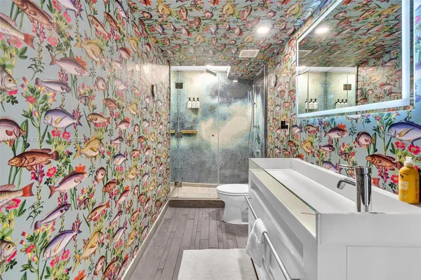 a bathroom with a sink toilet and shower