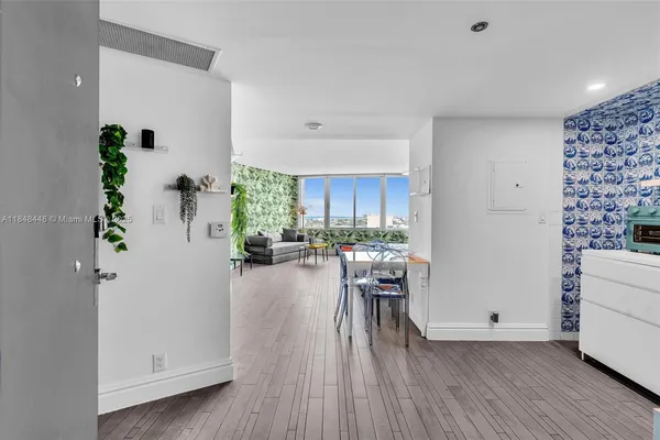 a view of a dining room with furniture window and wooden floor