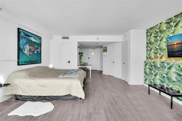 a spacious bedroom with a bed and a table