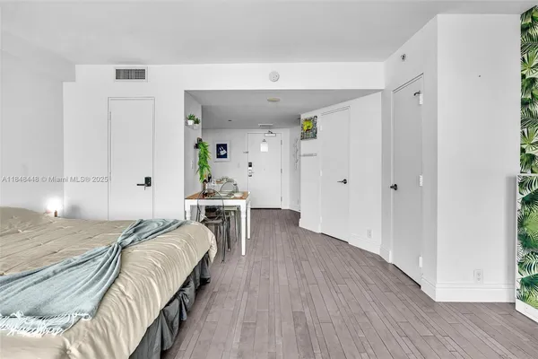 a bedroom with a bed couch and a window