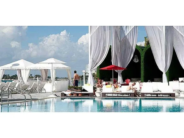 a view of a lake with boats and trees in the background