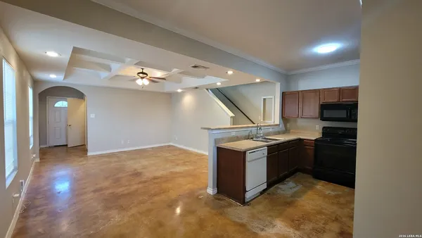 an empty room with kitchen view and appliances
