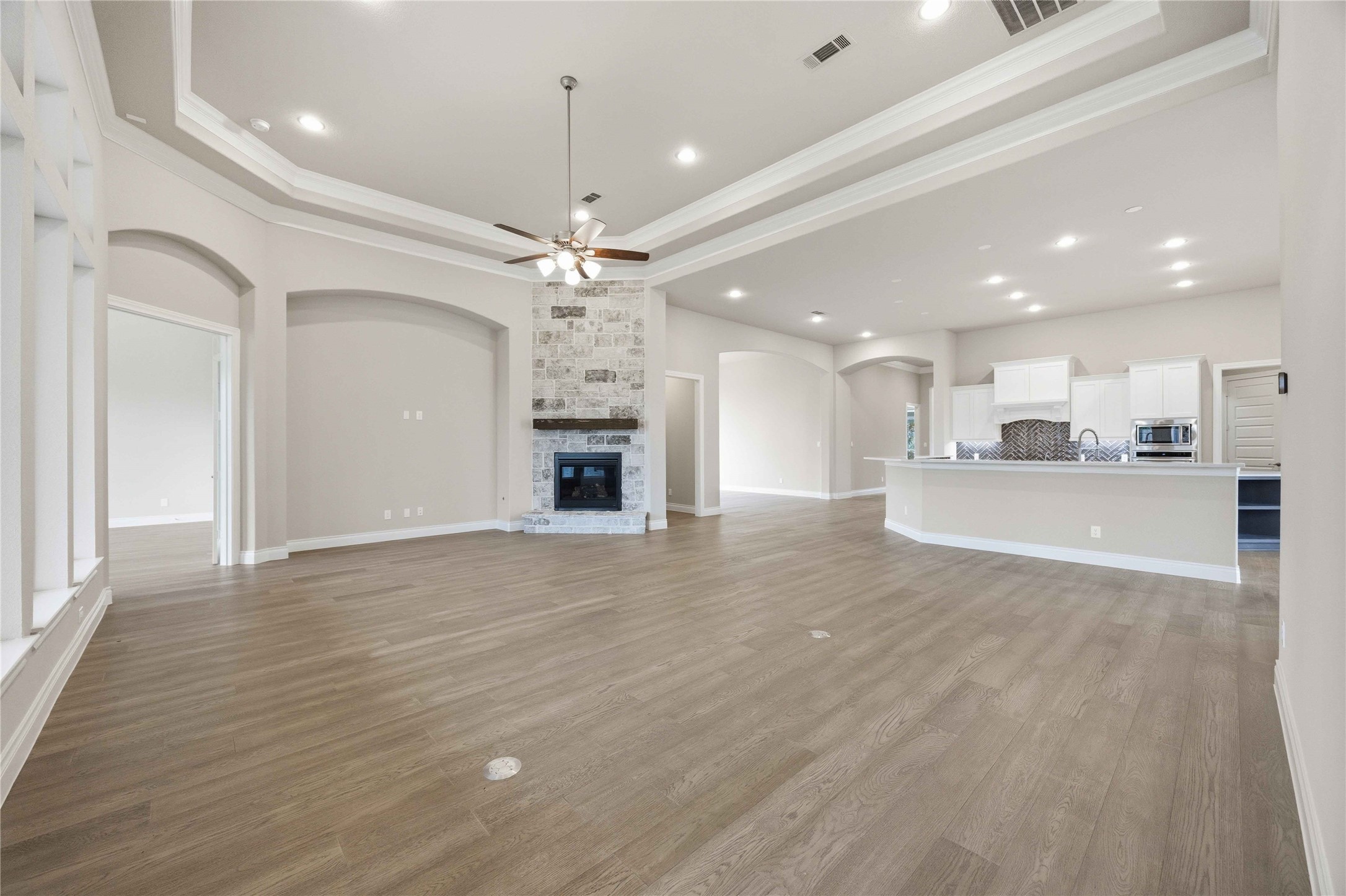 17564 Watercolor Way Conroe, TX 77302 - Photo 9 of 42 Elegant living room offers cozy fireplace, open concept and sweeping views of the backyard