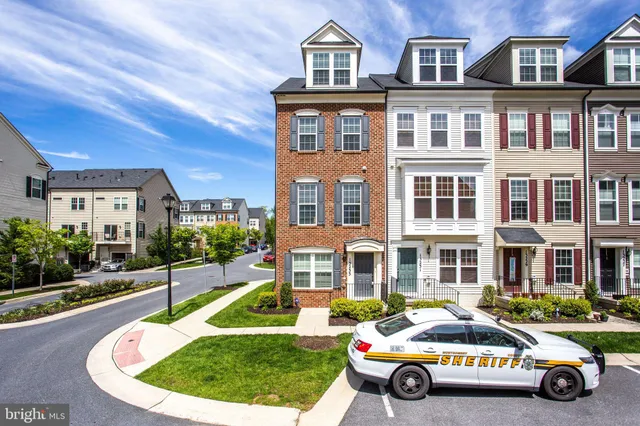 a car parked in front of a brick house